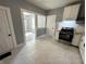 Kitchen showcasing tile floors, stainless appliances, white cabinets, and dining area view at 745 W 25Th St, Indianapolis, IN 46208