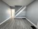 Bright living room featuring modern gray walls, stylish floors, and a staircase at 745 W 25Th St, Indianapolis, IN 46208