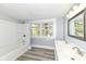 Bright bathroom featuring a tub, window, double sink and a modern mirror create a functional and stylish space at 821 S Lebanon St, Lebanon, IN 46052