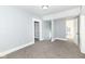 A bright bedroom featuring neutral colored walls and carpet is ready to be transformed into your personal retreat at 821 S Lebanon St, Lebanon, IN 46052