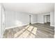 Spacious bedroom featuring neutral paint, new floors, and a door leading to additional rooms at 821 S Lebanon St, Lebanon, IN 46052