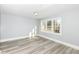Bright bedroom with neutral walls, a large window, and stylish flooring for a comfortable living space at 821 S Lebanon St, Lebanon, IN 46052