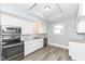 Well-lit kitchen featuring modern appliances, marble countertops, and wood-look flooring at 821 S Lebanon St, Lebanon, IN 46052