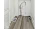 Compact laundry room with utility connections, white walls, and wood-look flooring at 821 S Lebanon St, Lebanon, IN 46052
