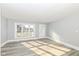Bright, freshly-painted living room with new flooring and large window providing ample natural light at 821 S Lebanon St, Lebanon, IN 46052