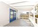 Covered porch showcasing a blue door, white railing, and built-in bench seating at 821 S Lebanon St, Lebanon, IN 46052