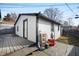 Cozy backyard features a gray deck and white exterior siding with black trim at 821 S Worth Ave, Indianapolis, IN 46241