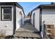 View of backyard with wooden walkway between buildings and access to yard at 821 S Worth Ave, Indianapolis, IN 46241