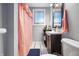 Bathroom featuring a sink with cabinet and a shower with a pink shower curtain at 821 S Worth Ave, Indianapolis, IN 46241