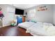 Bedroom with hardwood floors featuring two beds, a dresser and two windows at 821 S Worth Ave, Indianapolis, IN 46241