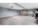 Spacious garage interior with gray concrete flooring, white walls, and a garage door at 821 S Worth Ave, Indianapolis, IN 46241