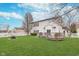 The backyard showcases a white house with a deck, a well-maintained lawn, vinyl fence and fire pit at 8335 S Shady Trail Dr, Pendleton, IN 46064