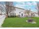 This large backyard offers a patio, a well-maintained lawn, a fire pit and a white vinyl fence at 8335 S Shady Trail Dr, Pendleton, IN 46064