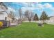 Spacious backyard features a wooden deck, lush green lawn, and a cozy fire pit area, perfect for outdoor entertaining at 8335 S Shady Trail Dr, Pendleton, IN 46064