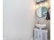 Bathroom with a round mirror and decorative wallpaper at 8335 S Shady Trail Dr, Pendleton, IN 46064