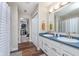 Bathroom featuring a double vanity and view into the walk-in closet at 8335 S Shady Trail Dr, Pendleton, IN 46064