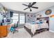 A well-decorated bedroom, furnished with a full bed, computer, and collectibles at 8335 S Shady Trail Dr, Pendleton, IN 46064
