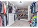 Custom walk-in closet with built-in shelving, hanging rods, and carpet flooring at 8335 S Shady Trail Dr, Pendleton, IN 46064