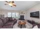 Comfortable living room featuring a plush sofa, fireplace, and a large screen television at 8335 S Shady Trail Dr, Pendleton, IN 46064