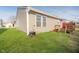 Well-maintained backyard showcasing a lush lawn, exterior vinyl siding and small back deck at 9049 Southernwood Way, Indianapolis, IN 46231