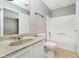 Bright bathroom featuring a granite-look sink, white vanity, and a shower-tub combination at 9049 Southernwood Way, Indianapolis, IN 46231