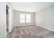 An empty carpeted bedroom with two bright windows at 9049 Southernwood Way, Indianapolis, IN 46231