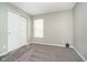 A carpeted bedroom with a closet and a window at 9049 Southernwood Way, Indianapolis, IN 46231