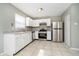 Bright kitchen with white cabinets, stainless steel appliances, and tile flooring at 9049 Southernwood Way, Indianapolis, IN 46231