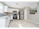 Kitchen featuring stainless steel appliances, white cabinetry, and tile flooring at 9049 Southernwood Way, Indianapolis, IN 46231