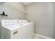 Laundry room featuring a standard size washer and dryer with white wire shelving above at 9049 Southernwood Way, Indianapolis, IN 46231