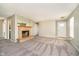 Open-concept living room featuring plush carpet, neutral paint, and a cozy fireplace at 9049 Southernwood Way, Indianapolis, IN 46231