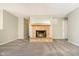 Cozy living room featuring plush carpet, neutral paint, and a cozy fireplace at 9049 Southernwood Way, Indianapolis, IN 46231