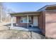 Charming brick home entrance featuring a cozy covered porch and a classic front door at 960 W 52Nd St, Indianapolis, IN 46208