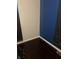 A corner room featuring dark hardwood flooring with gray and blue walls at 960 W 52Nd St, Indianapolis, IN 46208