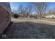 A view of the spacious yard that surrounds the property with trees enhancing privacy at 960 W 52Nd St, Indianapolis, IN 46208