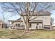 Backyard view with a large tree, deck with pergola, patio furniture, and outdoor fire pit at 10111 Ironway Dr, Indianapolis, IN 46239