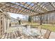 Outdoor living space under a pergola featuring a glass table and seating overlooking backyard at 10111 Ironway Dr, Indianapolis, IN 46239