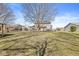 Expansive backyard view of the two-story home featuring a spacious lawn, deck, and pergola at 10111 Ironway Dr, Indianapolis, IN 46239
