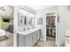 Elegant bathroom with double vanity, walk-in closet access, and neutral color scheme at 10111 Ironway Dr, Indianapolis, IN 46239