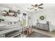 Bright bedroom with a window, ceiling fan, light gray walls and hardwood floors at 10111 Ironway Dr, Indianapolis, IN 46239