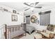 Cozy bedroom decorated with sports memorabilia, a crib, and a rocking chair at 10111 Ironway Dr, Indianapolis, IN 46239