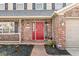 Charming two-story home featuring a brick and siding exterior with a welcoming red front door at 10111 Ironway Dr, Indianapolis, IN 46239