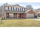 Charming two-story home featuring a brick and siding exterior with a welcoming front porch and two-car garage at 10111 Ironway Dr, Indianapolis, IN 46239