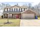 Charming two-story home featuring a brick and siding exterior with a welcoming front porch and two-car garage at 10111 Ironway Dr, Indianapolis, IN 46239