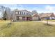 Charming two-story home featuring a brick and siding exterior with a welcoming front porch and two-car garage at 10111 Ironway Dr, Indianapolis, IN 46239