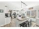 Modern kitchen with granite island, white cabinets, stainless steel appliances, and backyard access at 10111 Ironway Dr, Indianapolis, IN 46239