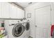Functional laundry room with washer, dryer, cabinets, and ample storage space at 10111 Ironway Dr, Indianapolis, IN 46239