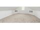 View of the finished attic showing the neutral carpet, a window, and cubbies built into the wall at 1026 Jefferson Ave, Indianapolis, IN 46201