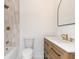 Bathroom featuring a bathtub, toilet and vanity with wood drawers and bronze hardware at 1026 Jefferson Ave, Indianapolis, IN 46201