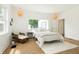 Bright bedroom with a large window overlooking the front yard and hardwood flooring at 1026 Jefferson Ave, Indianapolis, IN 46201
